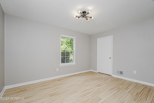 701 Zlotkin Cir Unit 1, Freehold, NJ 07728 - unfurnished room with wood finished floors and a chandelier