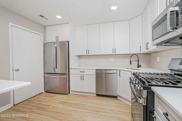 701 Zlotkin Cir Unit 1, Freehold, NJ 07728 - kitchen with appliances with stainless steel finishes, recessed lighting, white cabinets, light countertops, and light wood-type flooring