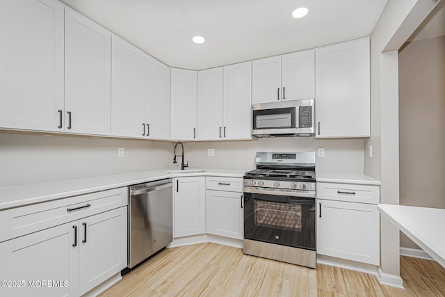 701 Zlotkin Cir Unit 1, Freehold, NJ 07728 - kitchen with stainless steel appliances, light wood finished floors, recessed lighting, white cabinetry, and light countertops