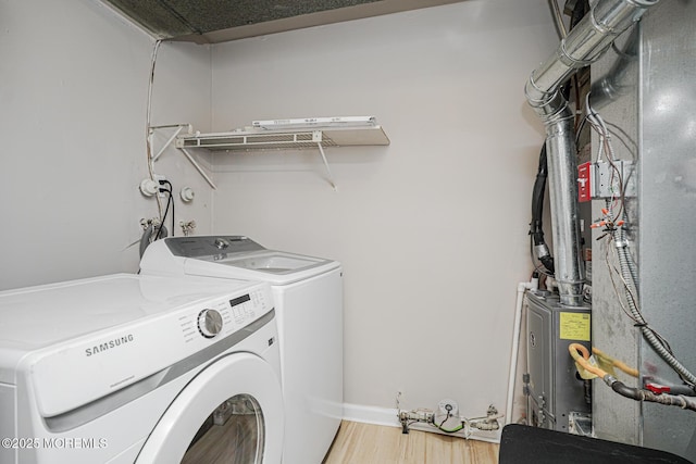 701 Zlotkin Cir Unit 1, Freehold, NJ 07728 - washroom featuring separate washer and dryer, light wood-type flooring, and heating unit