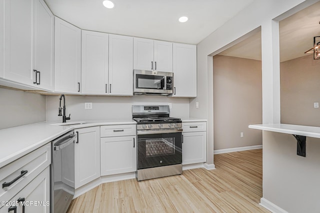701 Zlotkin Cir Unit 1, Freehold, NJ 07728 - kitchen with appliances with stainless steel finishes, white cabinetry, light wood-style floors, light countertops, and recessed lighting