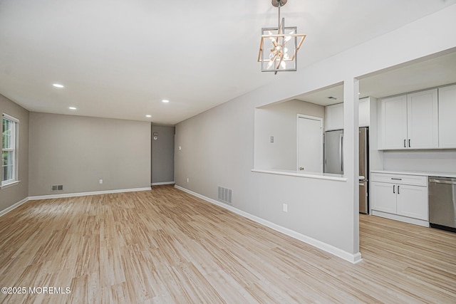 701 Zlotkin Cir Unit 1, Freehold, NJ 07728 - spare room with light wood-type flooring, recessed lighting, and a chandelier