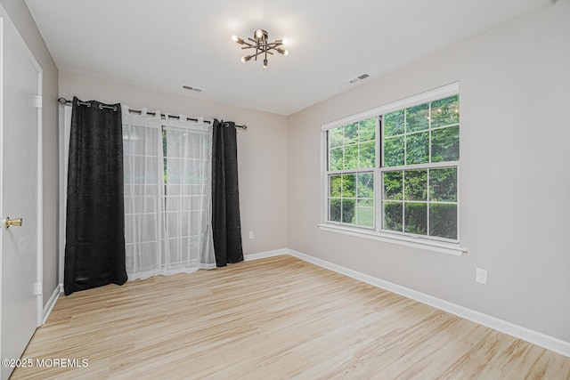 701 Zlotkin Cir Unit 1, Freehold, NJ 07728 - empty room with wood finished floors and a chandelier