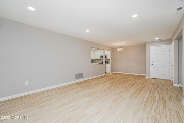 701 Zlotkin Cir Unit 1, Freehold, NJ 07728 - spare room featuring a chandelier, light wood-style floors, and recessed lighting