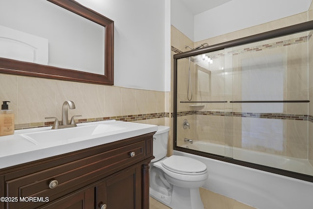 29 Lorton Rd, Old Bridge, NJ 08857 - bathroom with vanity, bath / shower combo with glass door, tile walls, tile patterned floors, and wainscoting