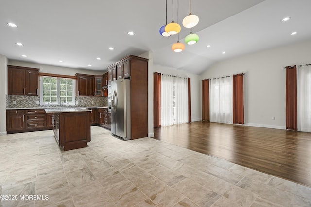 29 Lorton Rd, Old Bridge, NJ 08857 - kitchen with stainless steel refrigerator with ice dispenser, tasteful backsplash, open floor plan, a center island, and lofted ceiling