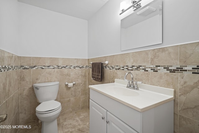 29 Lorton Rd, Old Bridge, NJ 08857 - half bathroom featuring vanity, tile walls, and a wainscoted wall