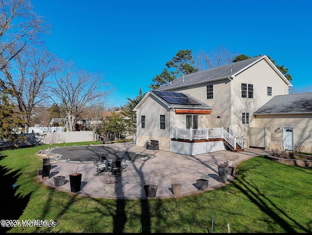 29 Lorton Rd, Old Bridge, NJ 08857 - back of property with a wooden deck, roof mounted solar panels, and a patio area