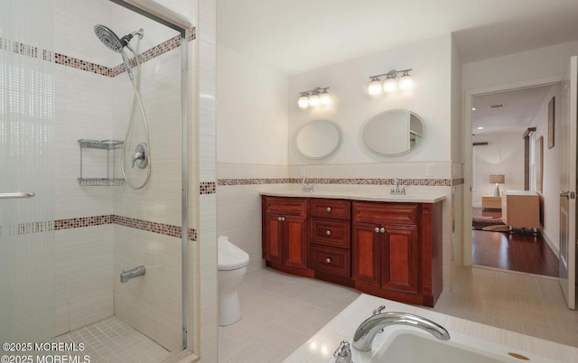 29 Lorton Rd, Old Bridge, NJ 08857 - full bathroom with tile walls, a shower stall, double vanity, tile patterned floors, and wainscoting