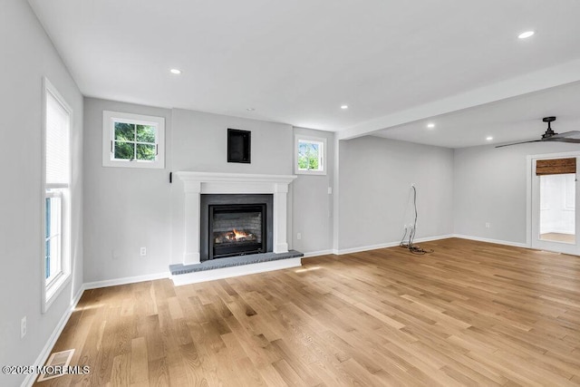 1207 Bayberry Rd, Manasquan, NJ 08736 - unfurnished living room featuring a glass covered fireplace, plenty of natural light, light wood-type flooring, and recessed lighting