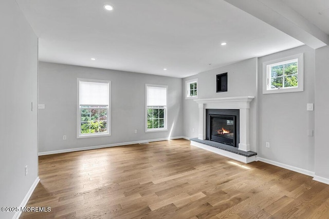 1207 Bayberry Rd, Manasquan, NJ 08736 - unfurnished living room with plenty of natural light, a glass covered fireplace, wood finished floors, and recessed lighting