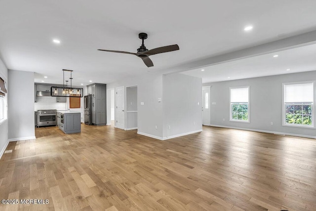 1207 Bayberry Rd, Manasquan, NJ 08736 - unfurnished living room featuring recessed lighting, a ceiling fan, light wood-type flooring, and a chandelier
