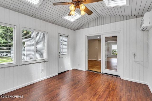 1207 Bayberry Rd, Manasquan, NJ 08736 - empty room with a skylight, a ceiling fan, dark wood-style flooring, lofted ceiling, and wood walls