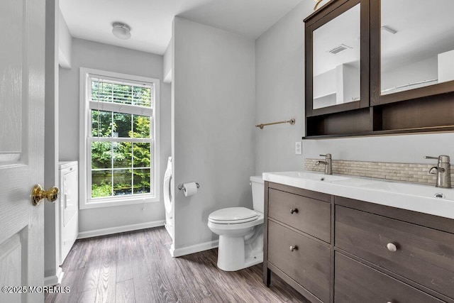 1207 Bayberry Rd, Manasquan, NJ 08736 - bathroom with wood finished floors, double vanity, and washer / clothes dryer