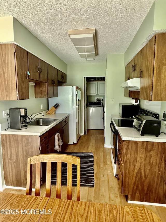7 S Seas Ct, Barnegat, NJ 08005 - kitchen featuring extractor fan, electric range, light wood-type flooring, light countertops, and a textured ceiling