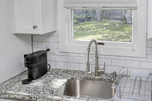 602 Butler Ave, Point Pleasant, NJ 08742 - kitchen view of decorative backsplash, white cabinetry, and light stone counters