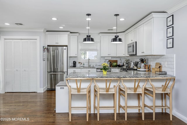 602 Butler Ave, Point Pleasant, NJ 08742 - kitchen with appliances with stainless steel finishes, a peninsula, decorative backsplash, white cabinetry, and light stone countertops
