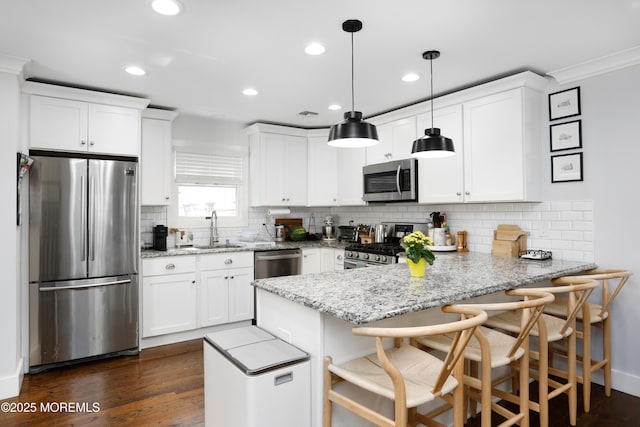 602 Butler Ave, Point Pleasant, NJ 08742 - kitchen featuring stainless steel appliances, a peninsula, white cabinetry, recessed lighting, and ornamental molding