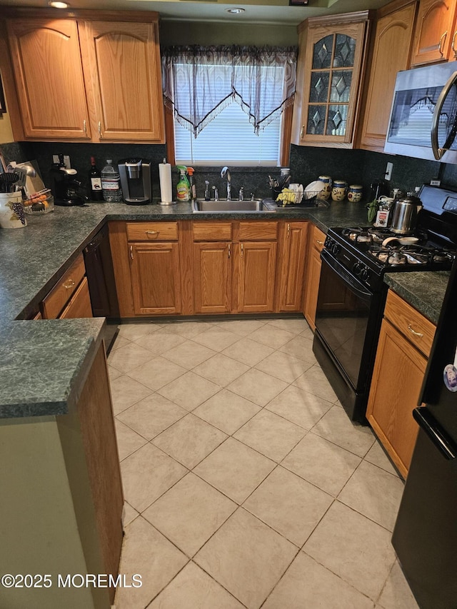 24 Christiansted St, Toms River, NJ 08757 - kitchen with black appliances, dark countertops, and brown cabinets