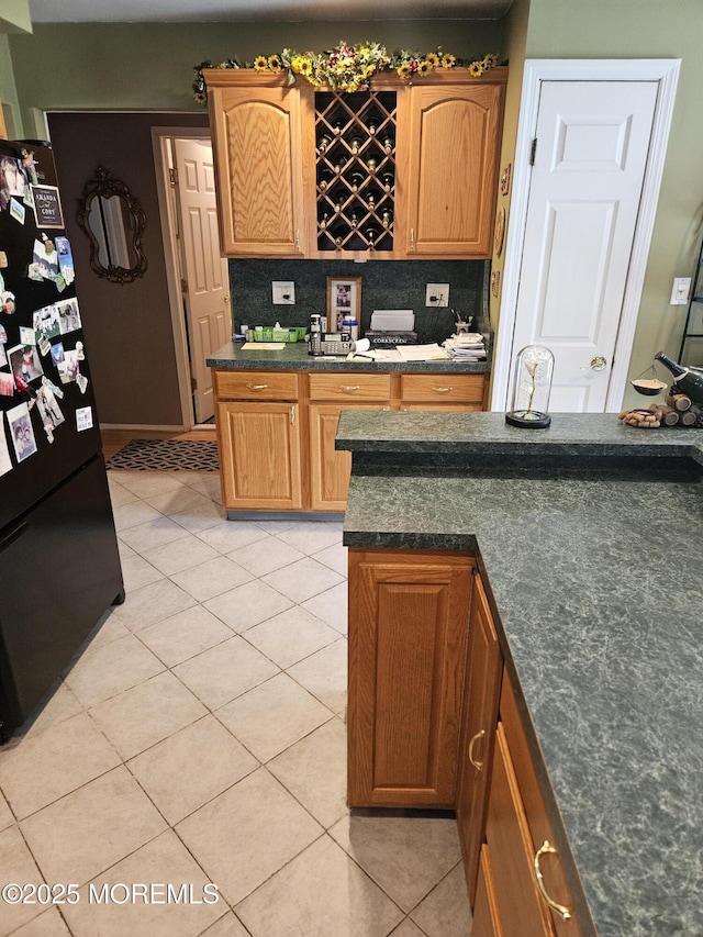 24 Christiansted St, Toms River, NJ 08757 - kitchen with freestanding refrigerator, light tile patterned floors, dark countertops, and backsplash