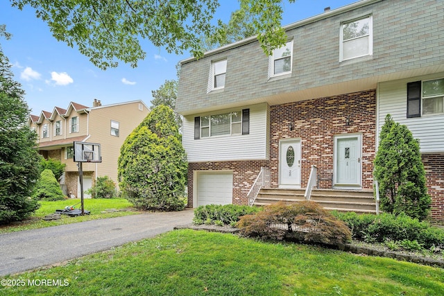 28 Dortmunder Dr, Manalapan, NJ 07726 - view of front facade with mansard roof, brick siding, an attached garage, and asphalt driveway