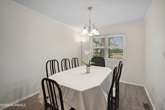28 Dortmunder Dr, Manalapan, NJ 07726 - dining room with a textured ceiling, a chandelier, wood finished floors, and crown molding