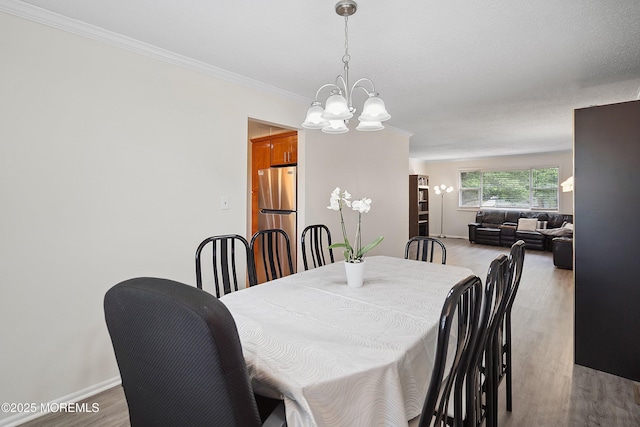 28 Dortmunder Dr, Manalapan, NJ 07726 - dining area with a chandelier, wood finished floors, and crown molding