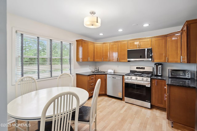 28 Dortmunder Dr, Manalapan, NJ 07726 - kitchen featuring appliances with stainless steel finishes, light wood-style flooring, brown cabinetry, and recessed lighting