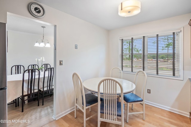28 Dortmunder Dr, Manalapan, NJ 07726 - dining room with light wood-style flooring and a chandelier