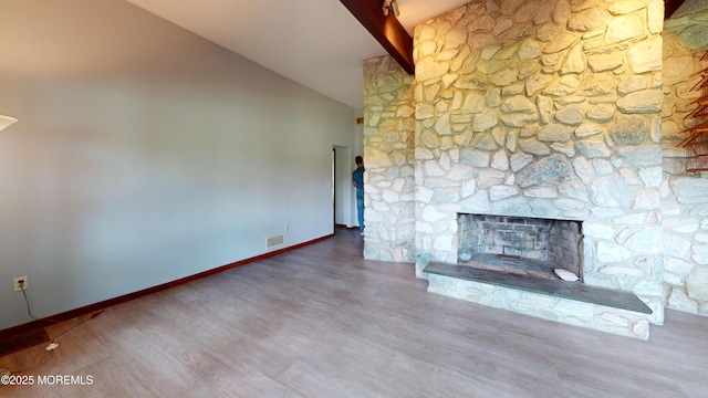 2 Patty Dr, Wrightstown, NJ 08562 - unfurnished living room featuring wood finished floors, high vaulted ceiling, beamed ceiling, and a stone fireplace