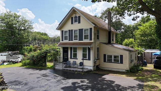 636 Holmdel Rd, Hazlet, NJ 07730 - traditional-style house with a porch and a chimney