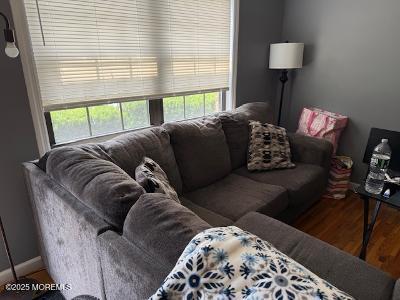 101 Village Green Way, Hazlet, NJ 07730 - living room featuring plenty of natural light and wood finished floors