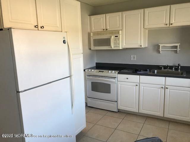 101 Village Green Way, Hazlet, NJ 07730 - kitchen featuring white appliances, dark countertops, white cabinets, and light tile patterned floors