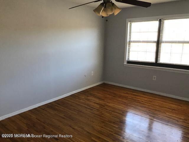 101 Village Green Way, Hazlet, NJ 07730 - spare room featuring ceiling fan and wood finished floors