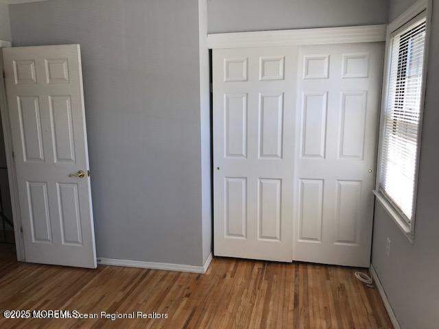 101 Village Green Way, Hazlet, NJ 07730 - unfurnished bedroom with a closet and wood finished floors