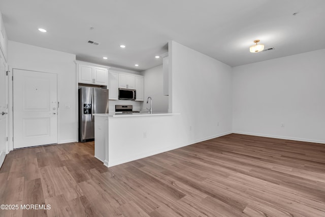 750 Lighthouse Dr Unit 3201, Barnegat, NJ 08005 - kitchen with appliances with stainless steel finishes, light wood finished floors, white cabinets, recessed lighting, and a peninsula