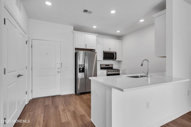 750 Lighthouse Dr Unit 3201, Barnegat, NJ 08005 - kitchen with stainless steel appliances, light wood-style floors, white cabinetry, a peninsula, and recessed lighting
