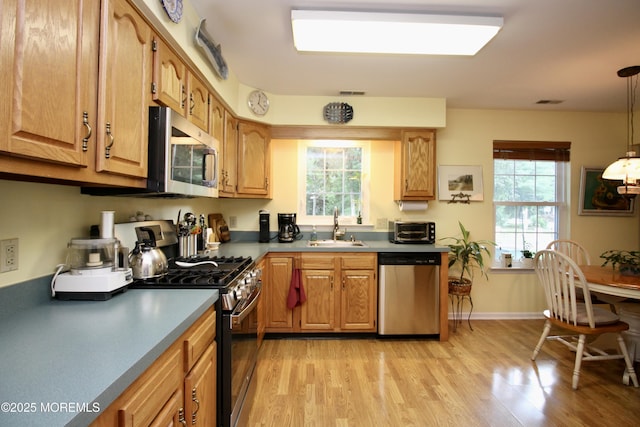 2 Dowing Ln, Jackson, NJ 08527 - kitchen featuring stainless steel appliances, light wood finished floors, pendant lighting, and brown cabinets
