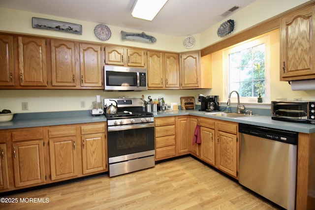 2 Dowing Ln, Jackson, NJ 08527 - kitchen featuring stainless steel appliances, light wood finished floors, and brown cabinetry