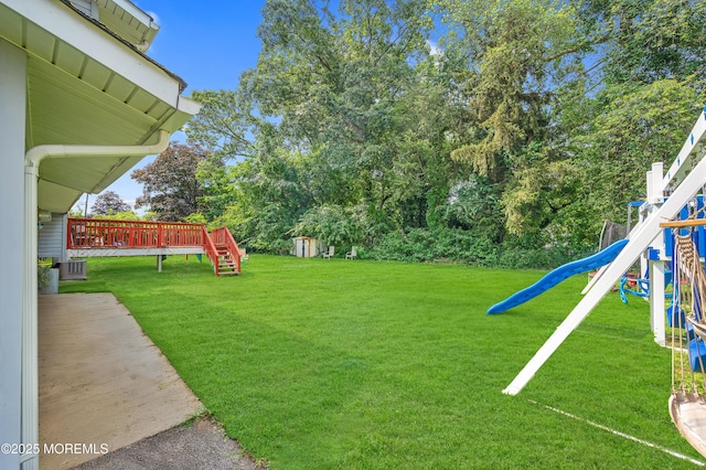 23 Montana Dr, Jackson, NJ 08527 - view of grassy yard with a playground, a wooden deck, and a shed