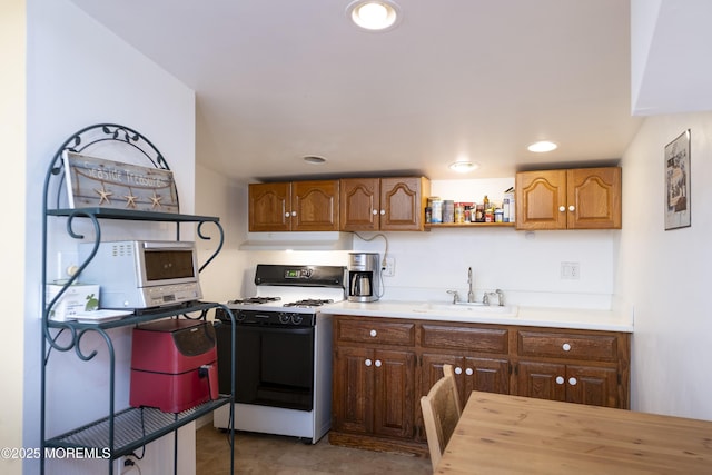 28 Florence Ave, Leonardo, NJ 07737 - kitchen featuring gas range oven, under cabinet range hood, open shelves, and brown cabinetry