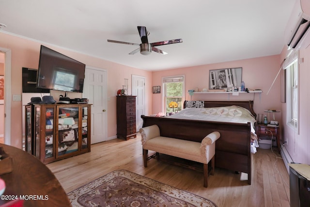 135 E Veterans Hwy, Jackson, NJ 08527 - bedroom featuring an AC wall unit, light wood-style floors, ceiling fan, and a baseboard radiator