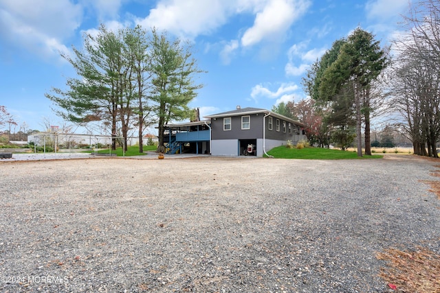 135 E Veterans Hwy, Jackson, NJ 08527 - view of front of house with gravel driveway, a chimney, stairway, and a carport