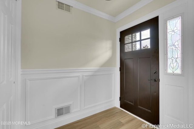 13 Everest Dr N, Brick, NJ 08724 - entrance foyer featuring a wainscoted wall, a decorative wall, ornamental molding, and light wood-type flooring