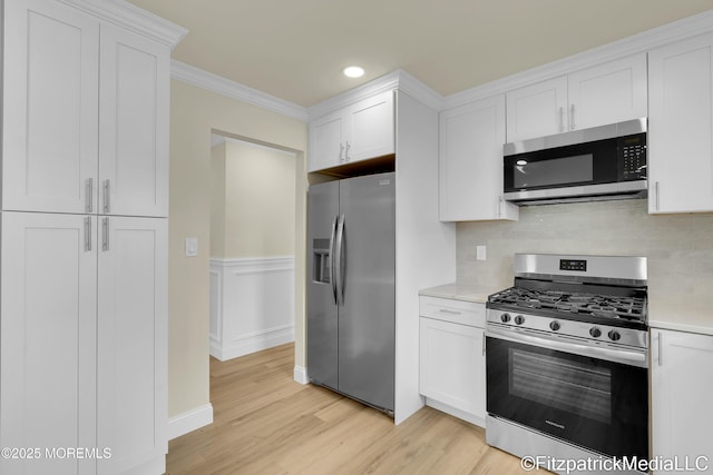 13 Everest Dr N, Brick, NJ 08724 - kitchen featuring stainless steel appliances, light countertops, light wood-style floors, white cabinetry, and ornamental molding