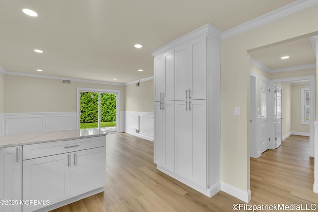 13 Everest Dr N, Brick, NJ 08724 - kitchen featuring white cabinets, ornamental molding, light wood-style flooring, wainscoting, and light stone countertops