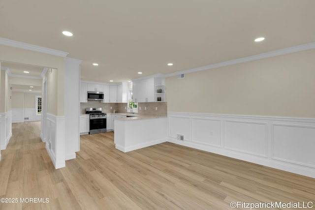 13 Everest Dr N, Brick, NJ 08724 - kitchen featuring open shelves, ornamental molding, appliances with stainless steel finishes, light countertops, and a decorative wall