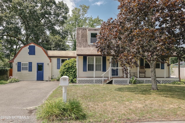 107 Seneca Lake Dr, Little Egg Harbor, NJ 08087 - view of front facade featuring a porch, a shingled roof, a front lawn, and a gambrel roof