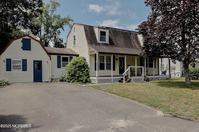107 Seneca Lake Dr, Little Egg Harbor, NJ 08087 - dutch colonial featuring a porch, a gambrel roof, roof with shingles, and a front lawn