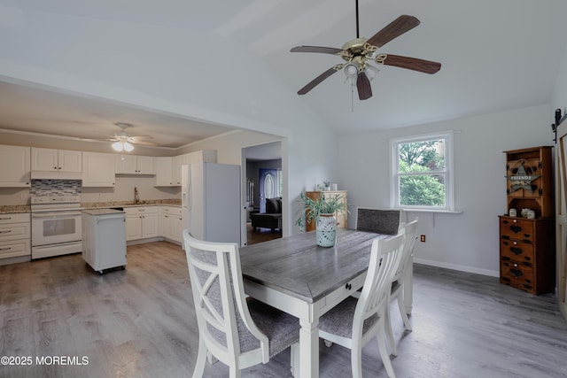 107 Seneca Lake Dr, Little Egg Harbor, NJ 08087 - dining room featuring ceiling fan, vaulted ceiling, and light wood-style flooring